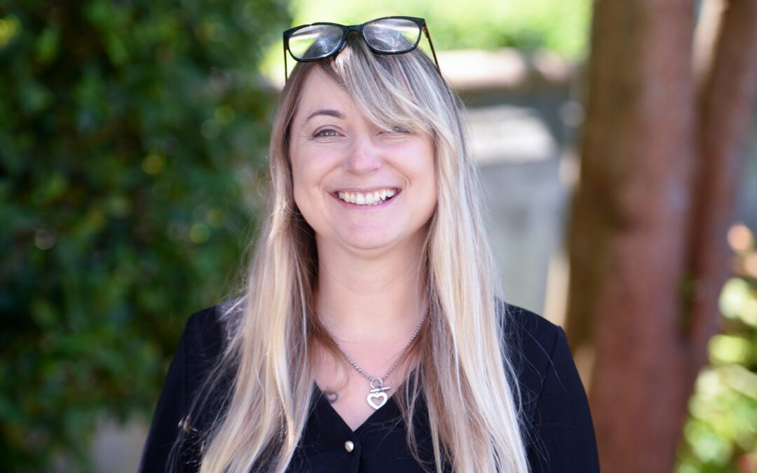 Photograph of Kate Faust in front of trees